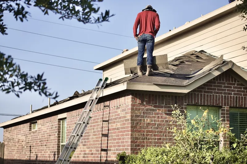 Professional roofer working on a residential roof in Hainesburg